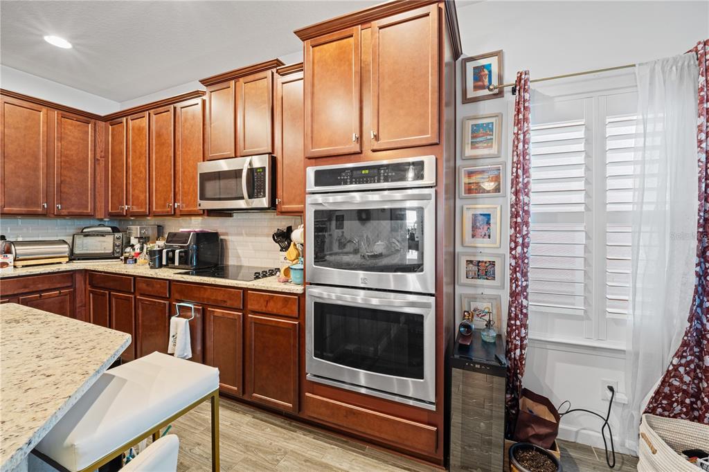 1722 Reflection Lane St. Cloud, FL 34771 - Photo 14 of 26 a kitchen with stainless steel appliances granite countertop a stove a sink and a microwave