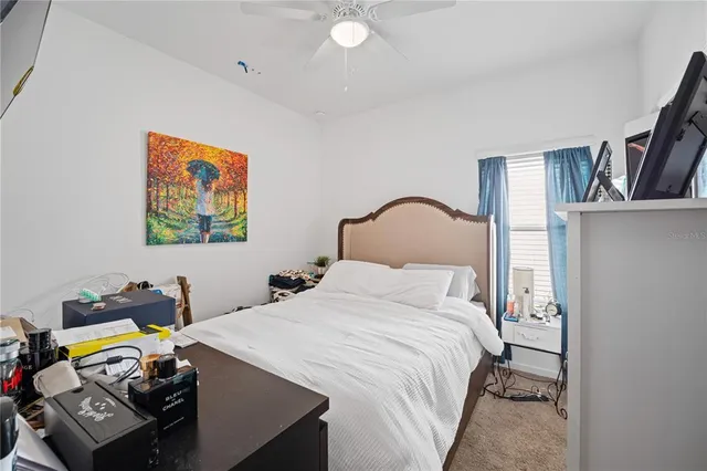 a bedroom with a bed and a desk