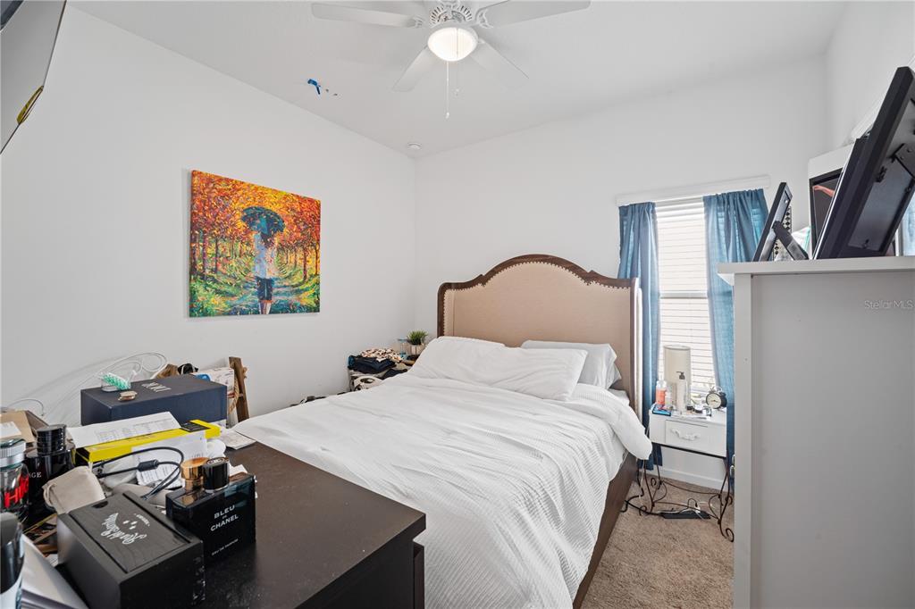 1722 Reflection Lane St. Cloud, FL 34771 - Photo 16 of 26 a bedroom with a bed and a desk