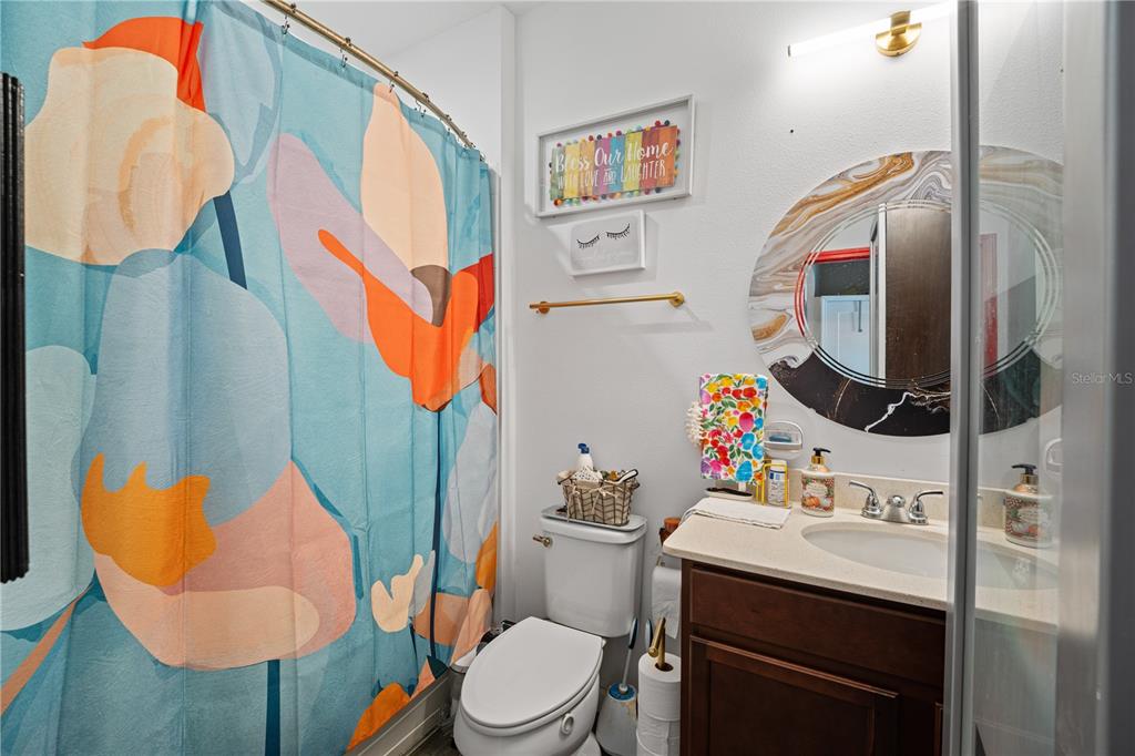 1722 Reflection Lane St. Cloud, FL 34771 - Photo 17 of 26 a bathroom with a sink mirror and toilet