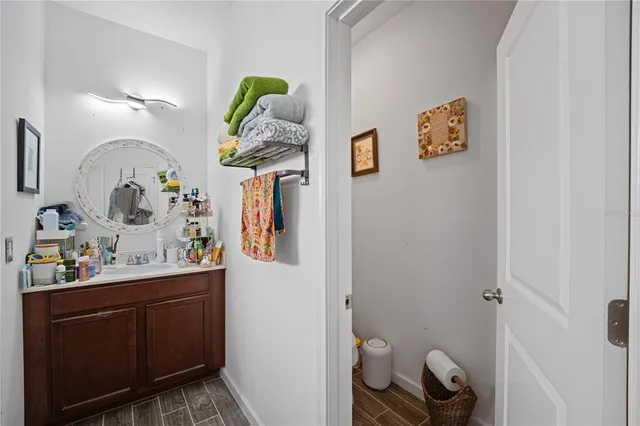 a bathroom with a sink mirror and toilet