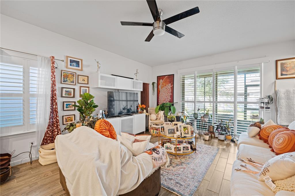 1722 Reflection Lane St. Cloud, FL 34771 - Photo 25 of 26 a living room with furniture and floor to ceiling windows