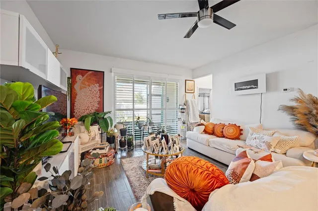 a living room with furniture and a potted plant