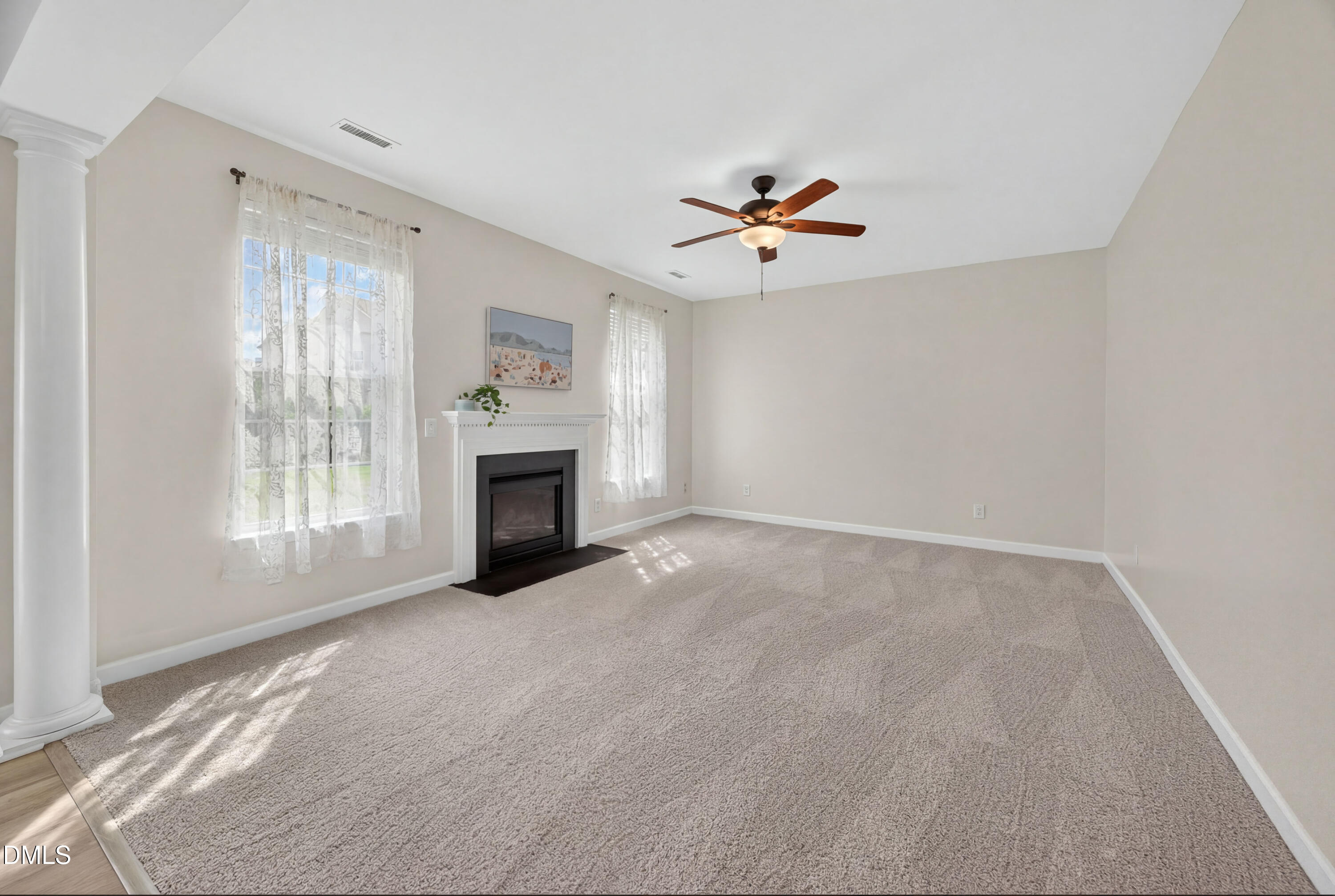 5304 Stone Station Drive Raleigh, NC 27616 - Photo 11 of 34 a view of empty room with a fireplace and fan