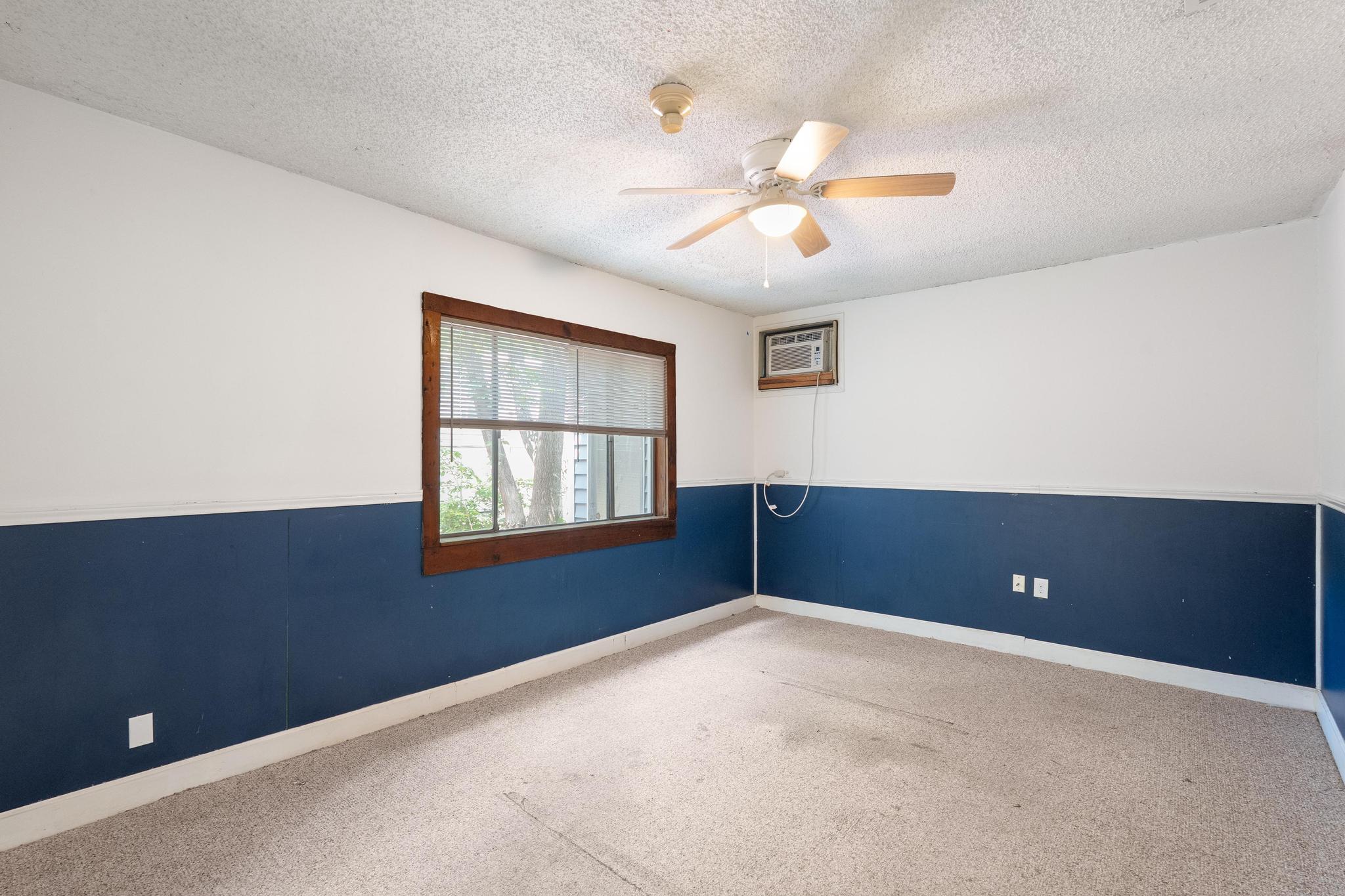 4616 East Cesar Chavez Street Austin, TX 78702 - Photo 11 of 22 an empty room with windows and chandelier fan