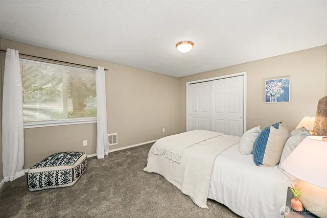 a bedroom with a bed and a window