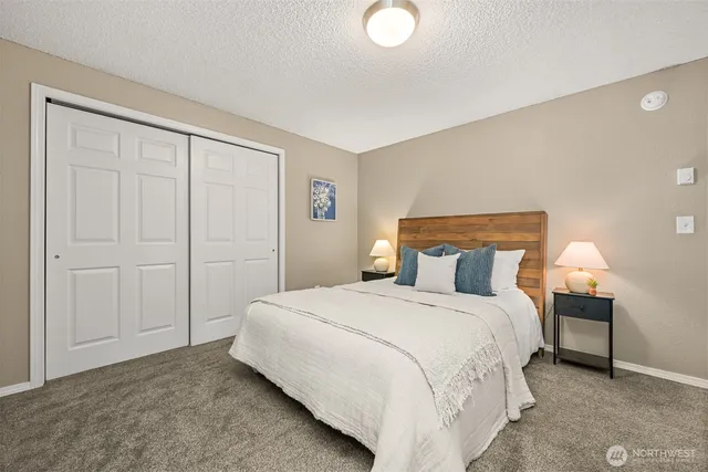 a bedroom with a bed and a lamp