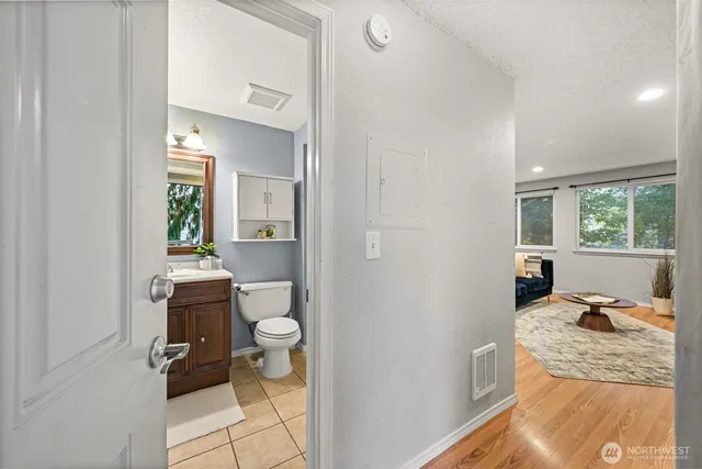 a bathroom with a toilet a sink and a mirror