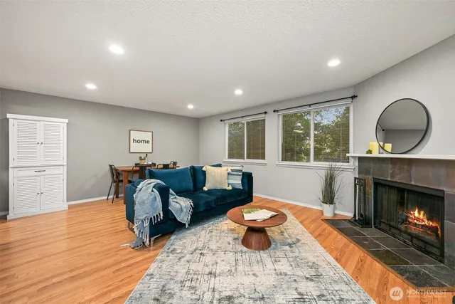 a living room with furniture a window and a fireplace