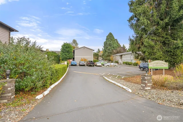 a house view with a car parked beside of it