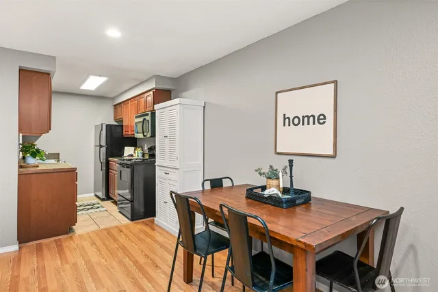 a kitchen with a table chairs and refrigerator