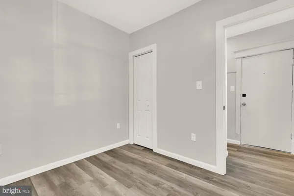 a kitchen with a refrigerator a stove top oven a sink and dishwasher with wooden floor