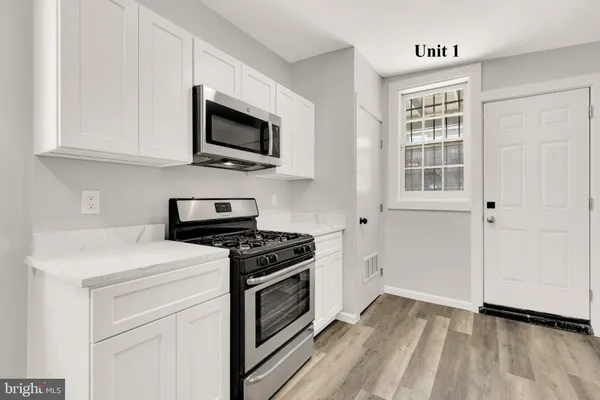 a bathroom with a sink toilet a mirror and shower