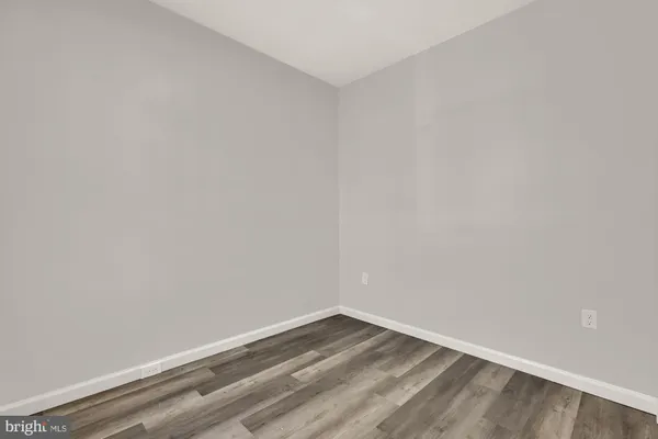 a kitchen with cabinets stainless steel appliances and wooden floor