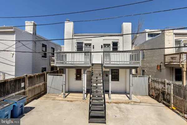 a kitchen with wooden floors and white appliances