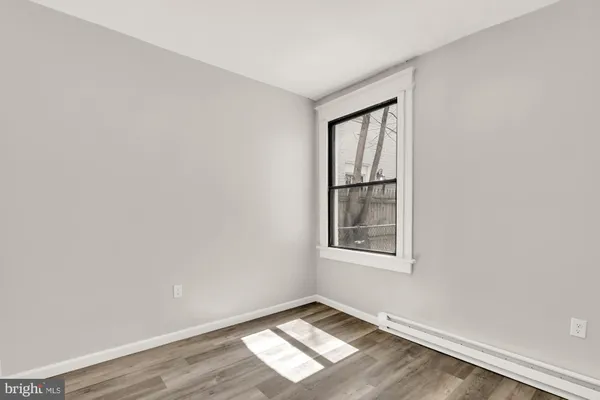 a kitchen with stainless steel appliances a refrigerator a stove top oven and wooden floor