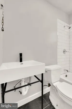 a kitchen with a refrigerator a stove top oven a sink and dishwasher with wooden floor