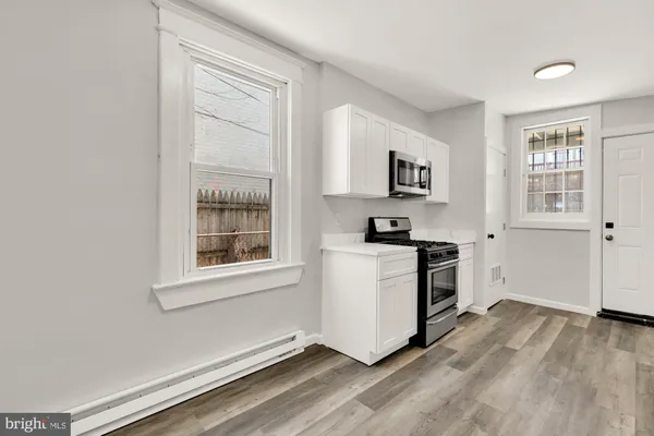 a kitchen with stainless steel appliances a refrigerator and a stove top oven