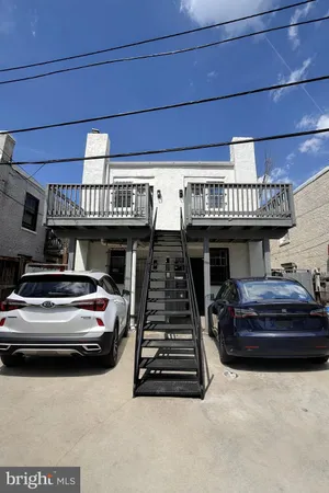 a kitchen with stainless steel appliances white cabinets and a refrigerator