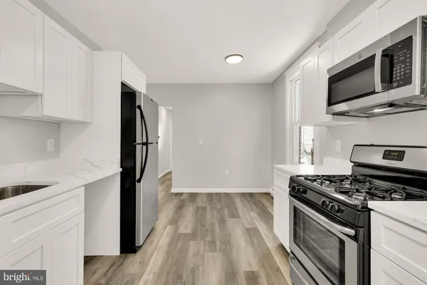 a view of a hallway with wooden floor and entryway