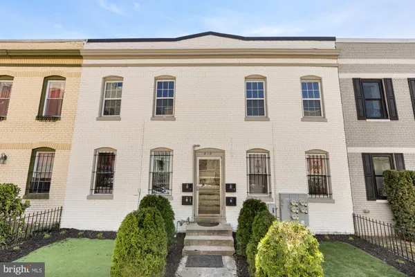 a front view of a building with garden