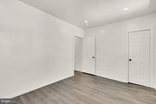 a kitchen with cabinets stainless steel appliances and wooden floor