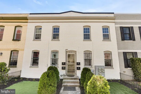 a kitchen with stainless steel appliances white cabinets and a stove top oven