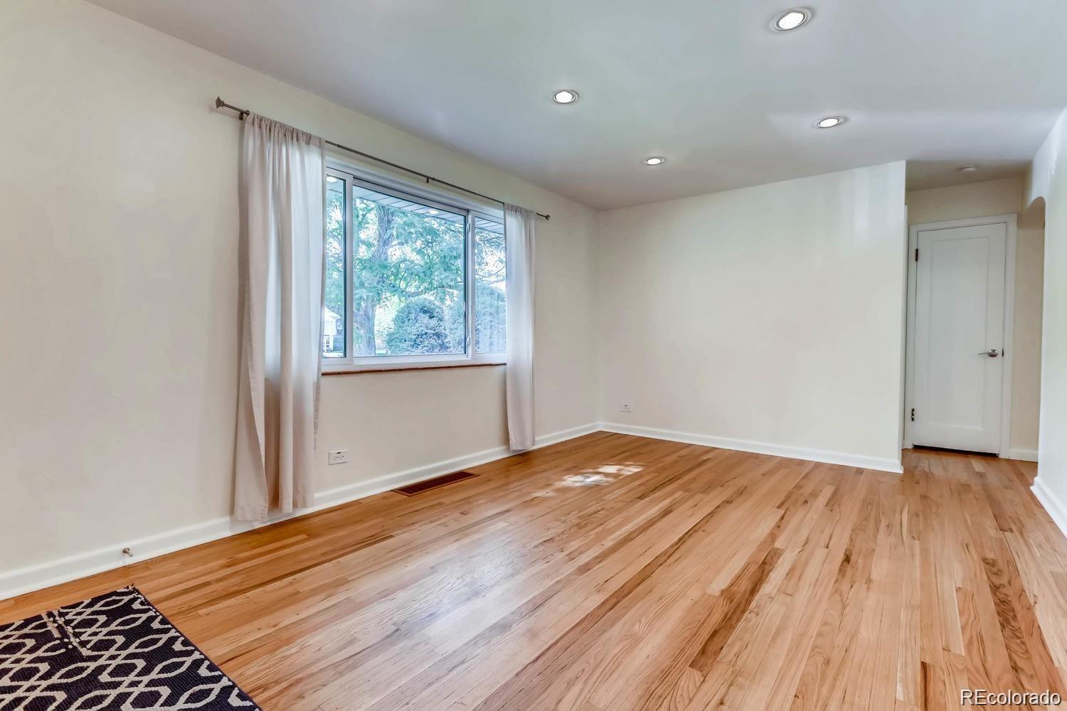 1610 South Cook Street Denver, CO 80210 - Photo 11 of 37 a view of an empty room with wooden floor and a window