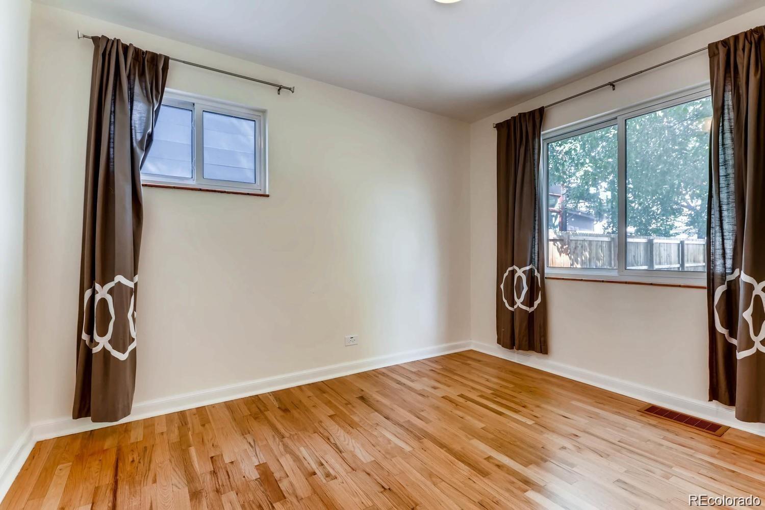 1610 South Cook Street Denver, CO 80210 - Photo 13 of 37 a view of empty room with wooden floor and fan
