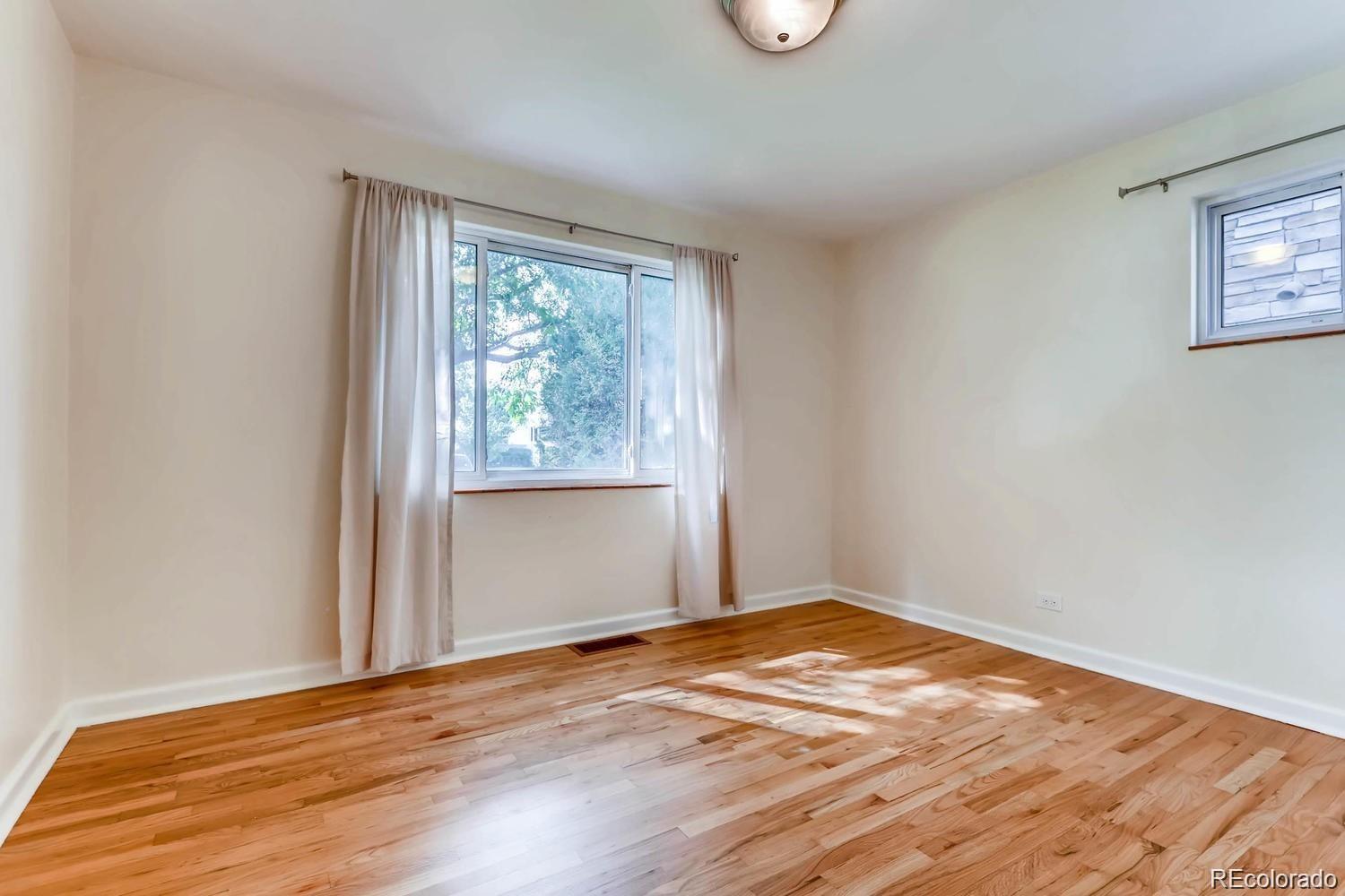 1610 South Cook Street Denver, CO 80210 - Photo 15 of 37 a view of empty room with wooden floor and fan