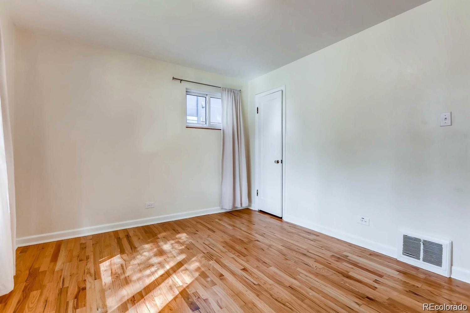 1610 South Cook Street Denver, CO 80210 - Photo 16 of 37 a view of empty room with wooden floor and fan