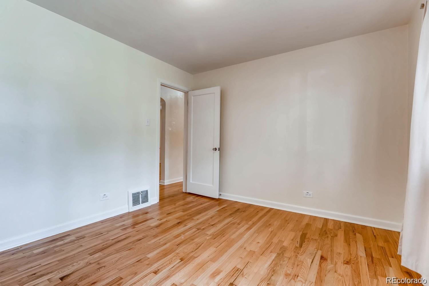 1610 South Cook Street Denver, CO 80210 - Photo 17 of 37 a view of empty room with wooden floor