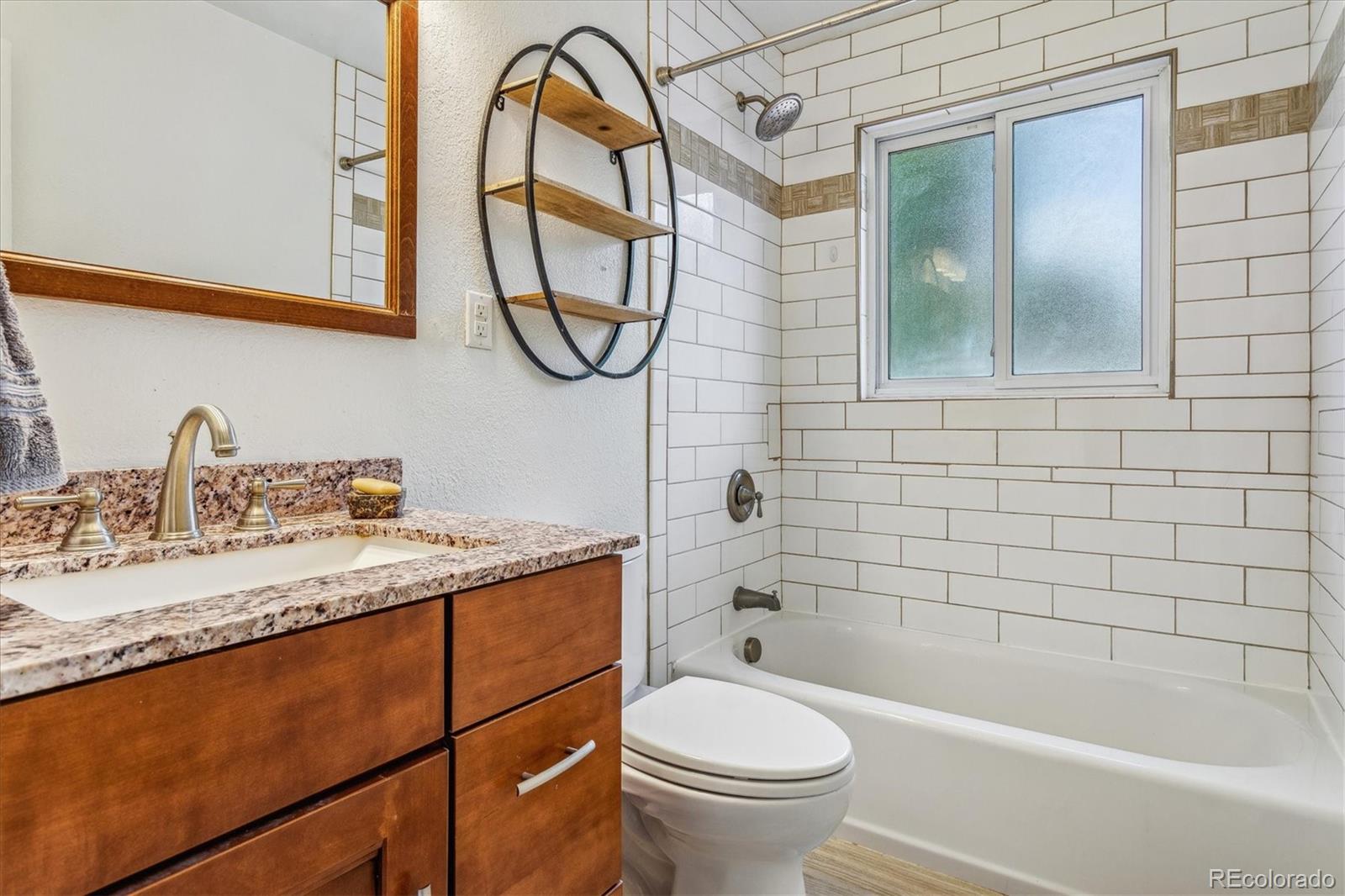 1610 South Cook Street Denver, CO 80210 - Photo 18 of 37 a bathroom with a granite countertop sink mirror toilet and bathtub