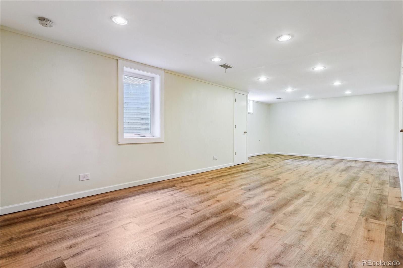 1610 South Cook Street Denver, CO 80210 - Photo 20 of 37 an empty room with wooden floor and windows