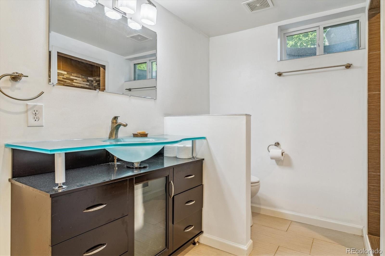 1610 South Cook Street Denver, CO 80210 - Photo 21 of 37 a bathroom with a granite countertop sink and a mirror