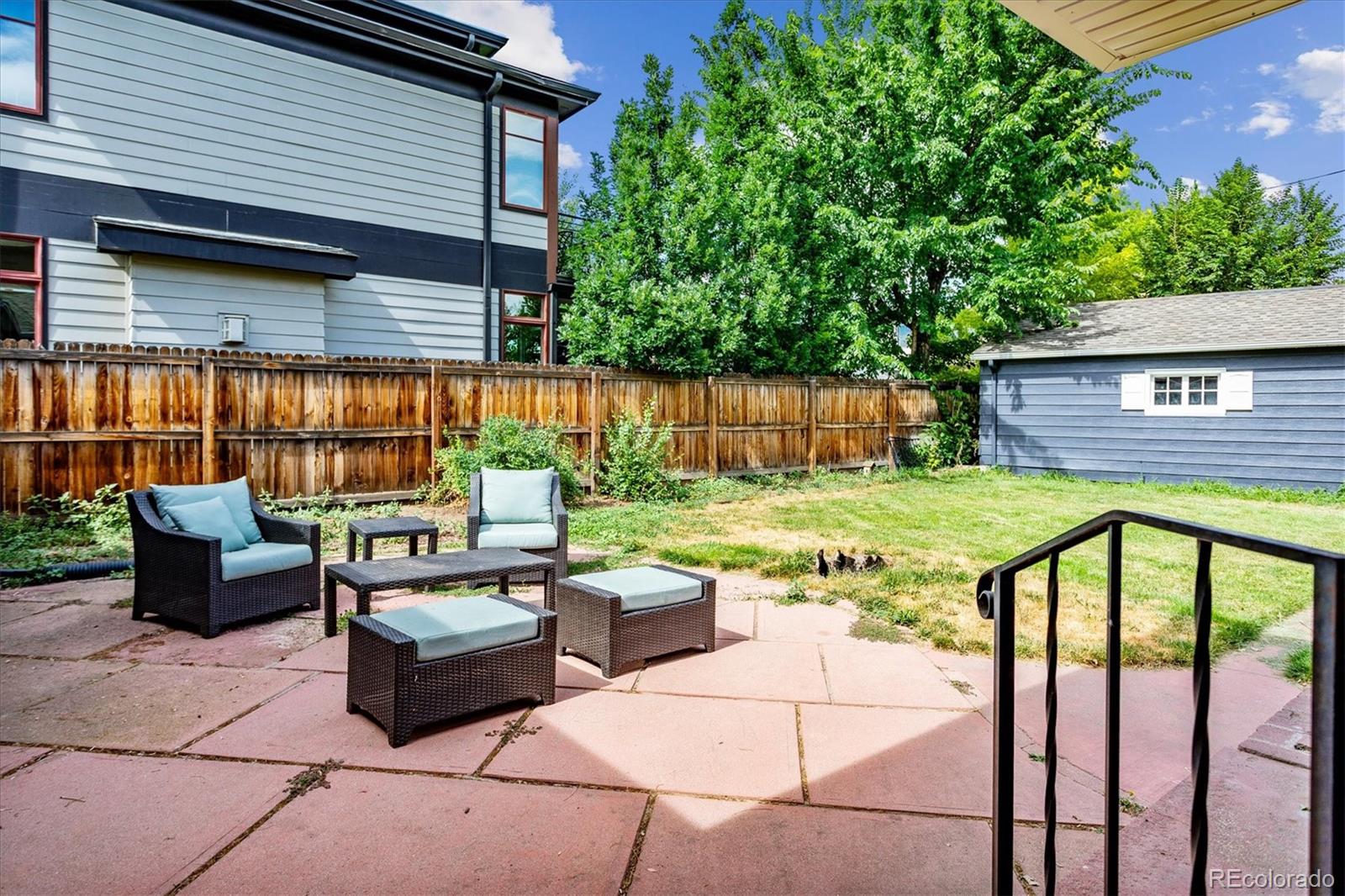 1610 South Cook Street Denver, CO 80210 - Photo 30 of 37 a view of a patio with couches chairs potted plants and floor to ceiling window