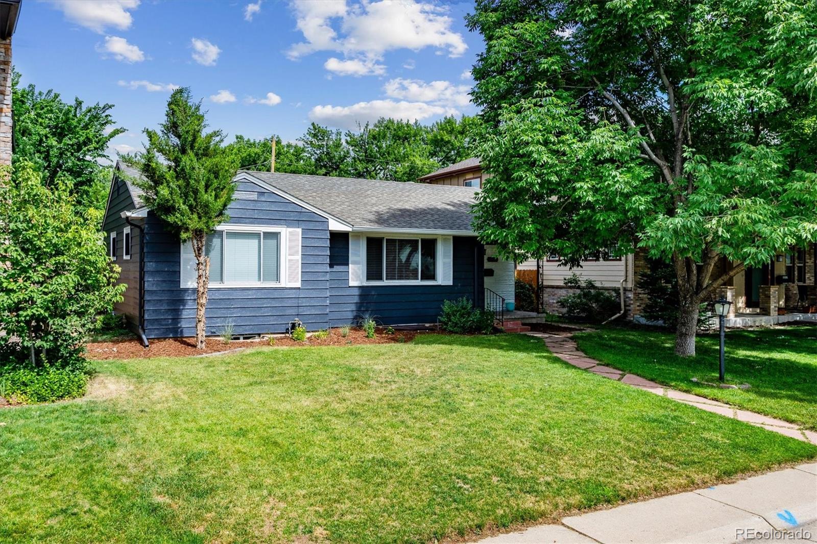 1610 South Cook Street Denver, CO 80210 - Photo 3 of 37 a front view of a house with a garden