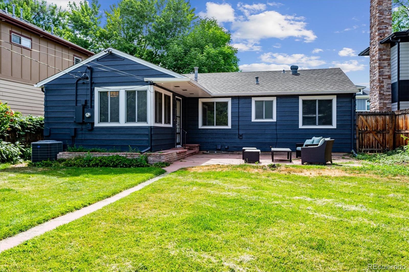 1610 South Cook Street Denver, CO 80210 - Photo 31 of 37 a front view of a house with a yard