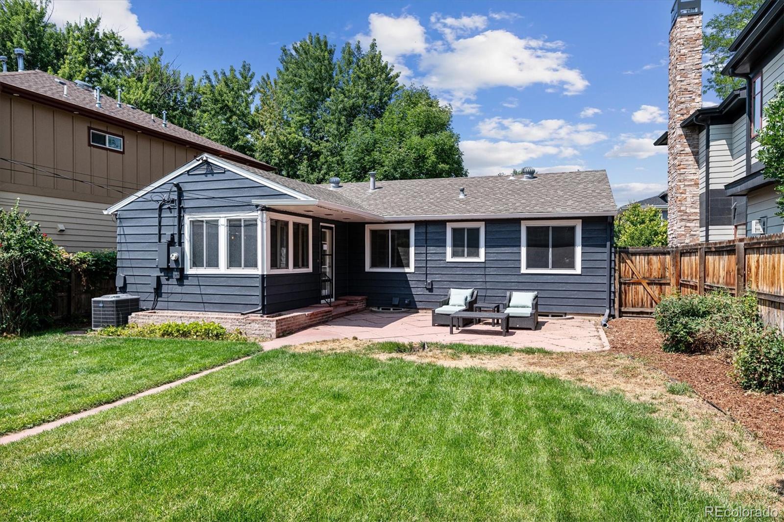 1610 South Cook Street Denver, CO 80210 - Photo 32 of 37 a view of a house with backyard sitting area and garden