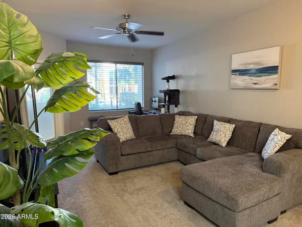 a living room with kitchen island furniture and a chandelier