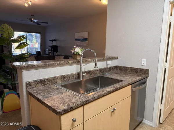 a kitchen with a sink and a refrigerator