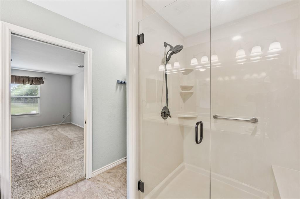 3931 Alpha Way Midlothian, TX 76065 - Photo 19 of 33 a bathroom with a glass shower door and a sink