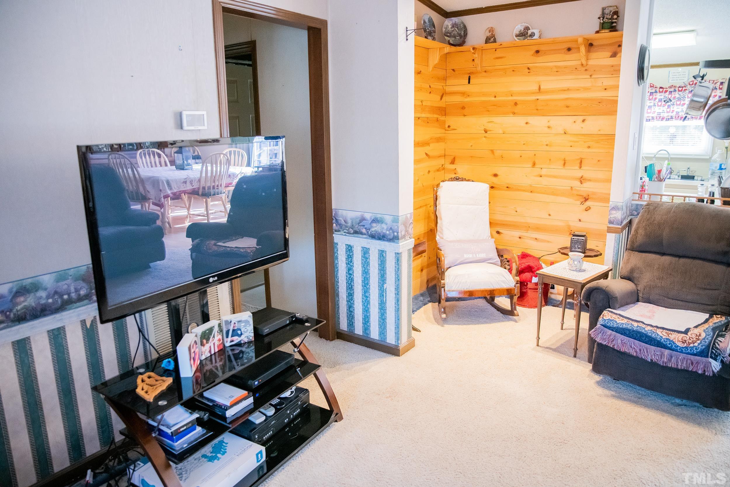 6180 Helena Moriah Road Rougemont, NC 27572 - Photo 12 of 41 a living room with furniture and a book shelf