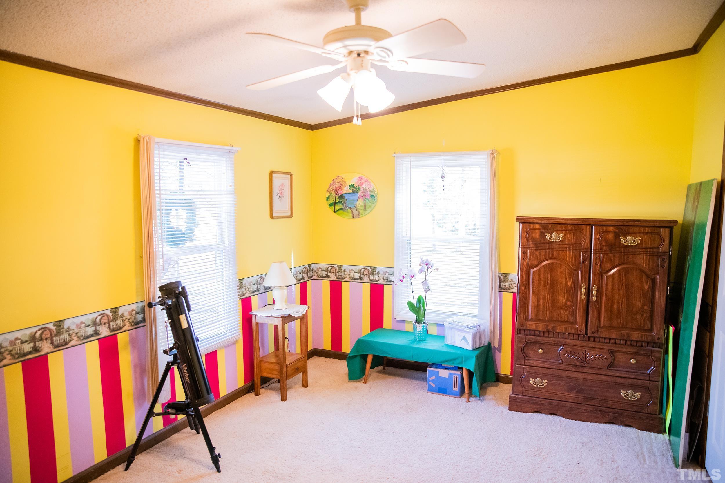6180 Helena Moriah Road Rougemont, NC 27572 - Photo 15 of 41 a view of a bedroom with gym equipment