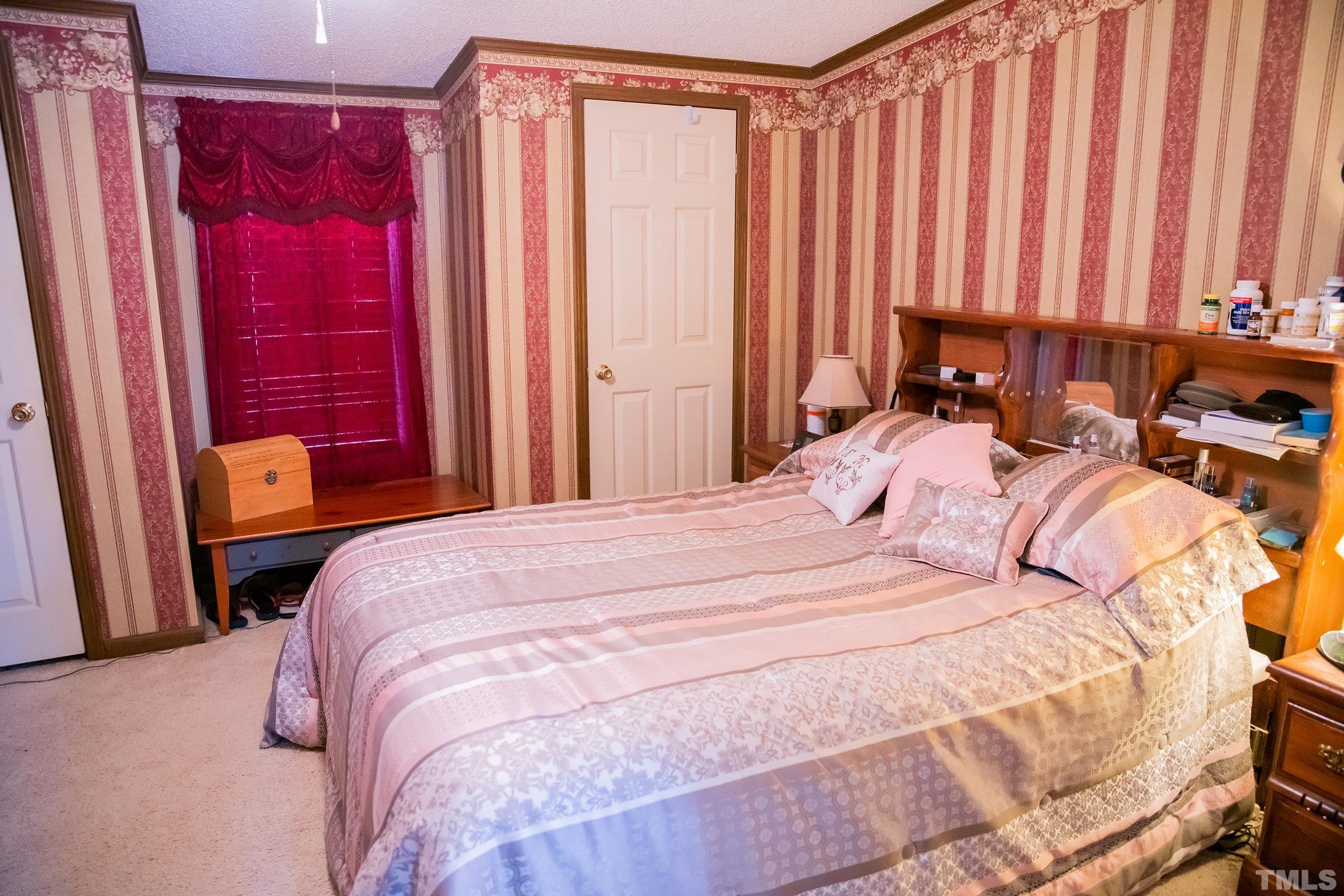 6180 Helena Moriah Road Rougemont, NC 27572 - Photo 20 of 41 a bedroom with a bed and a window