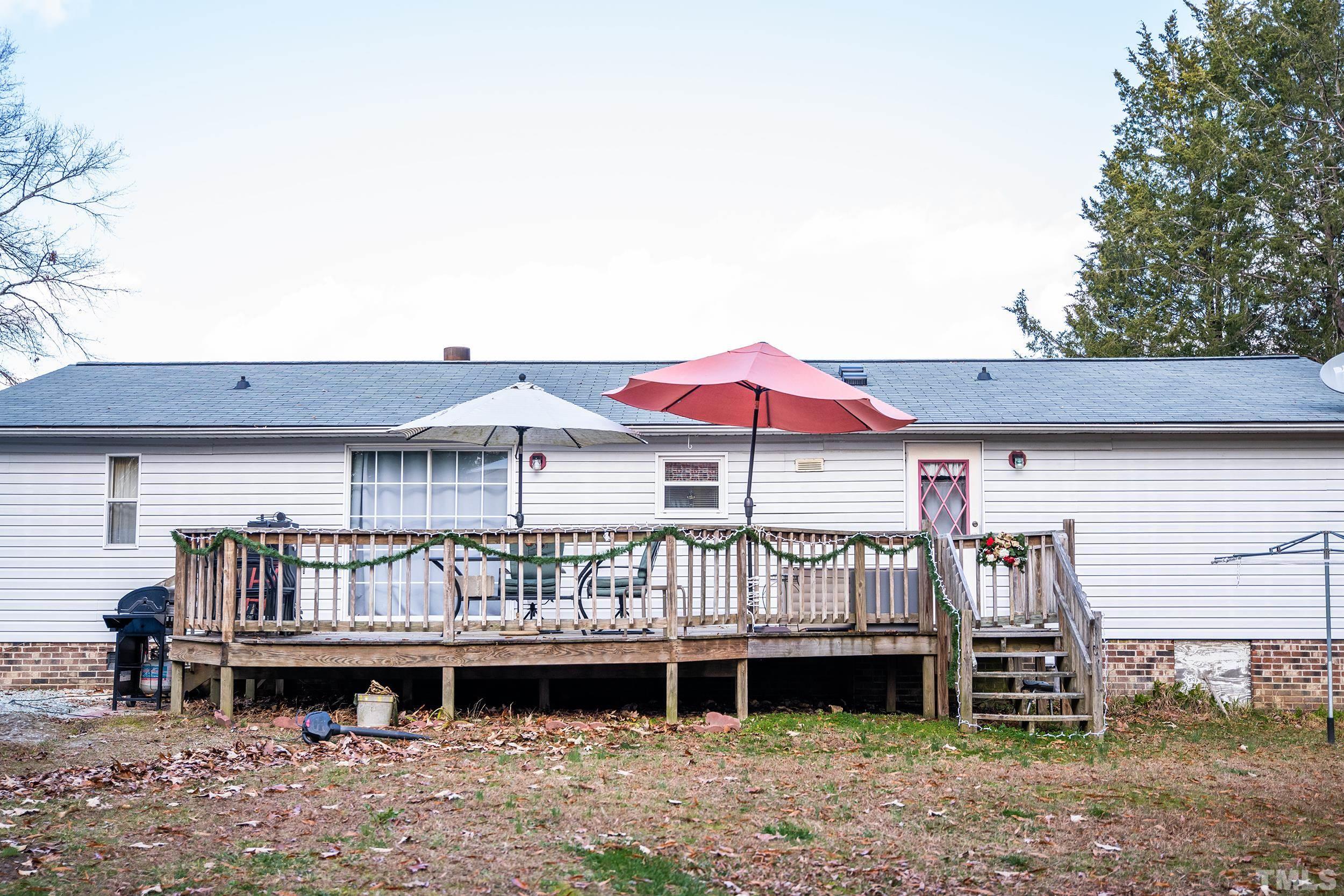 6180 Helena Moriah Road Rougemont, NC 27572 - Photo 2 of 41 a backyard of a house with barbeque oven and outdoor seating
