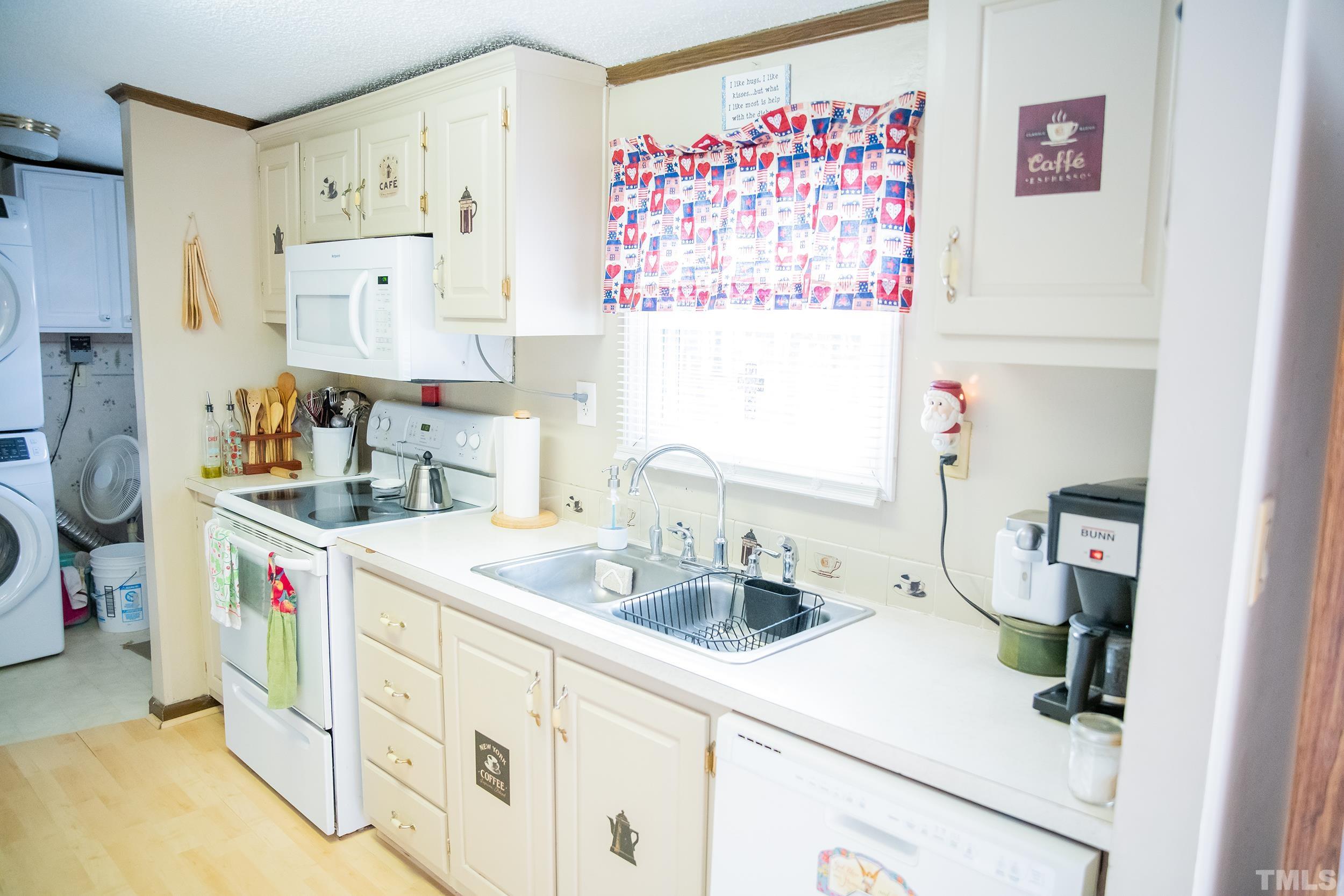 6180 Helena Moriah Road Rougemont, NC 27572 - Photo 4 of 41 a kitchen with cabinets a sink and white appliances