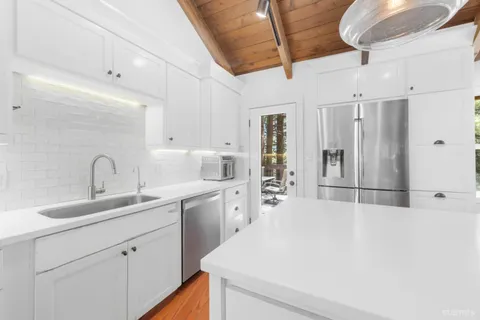 a view of balcony with wooden floor and outdoor seating