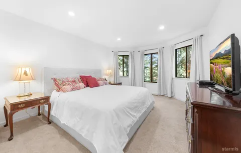 a spacious bathroom with a double vanity sink a mirror and a bathtub