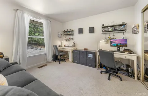 a spacious bathroom with a double vanity sink a mirror a bathtub and shower